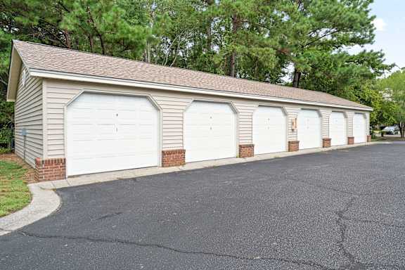 A long building with four garage doors at Litchfield Oaks Apartments in Pawleys Island, South Carolina