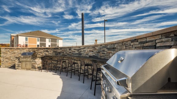 a patio with tables and chairs and a barbecue grill at The View at Blue Ridge in Roanoke, VA