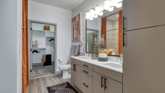 a bathroom with a large mirror and a sink and a toilet at Aura Stonebridge, Richmond, VA
