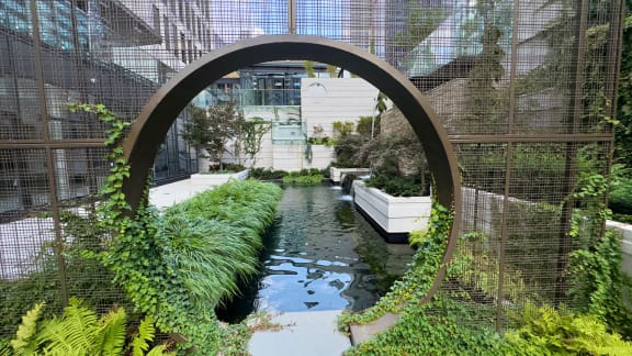 an indoor garden with water and plants in a greenhouse at Preston Centre, Columbus, 43215
