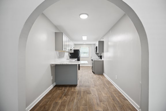 a kitchen and living room with white walls and wood floors at Shellbrook, NC 27609