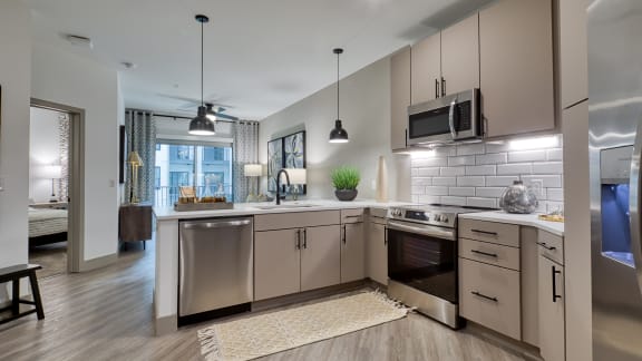 an open kitchen with stainless steel appliances and white counter tops at Aura Stonebridge, Richmond, Virginia, 23225