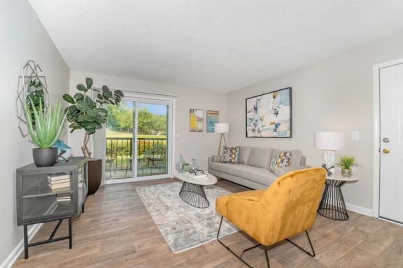 a living room with a couch and a door to a balcony