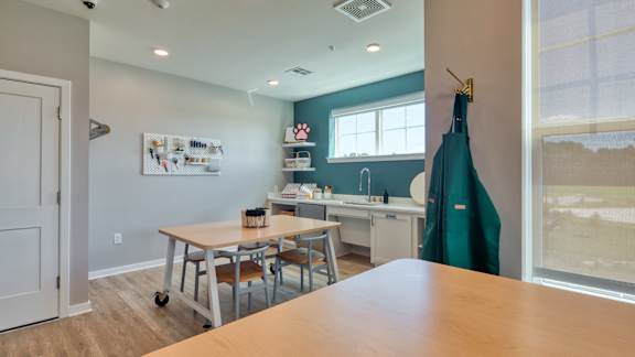 A room with a table and chairs in it.