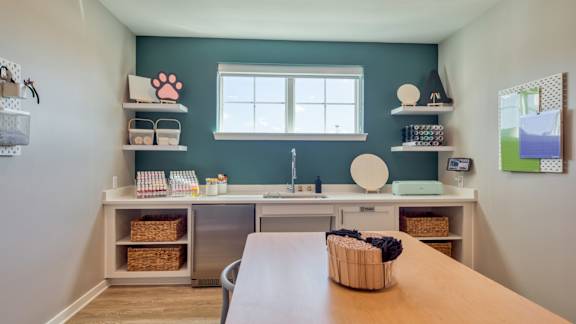 A kitchen with a wooden table and a window.