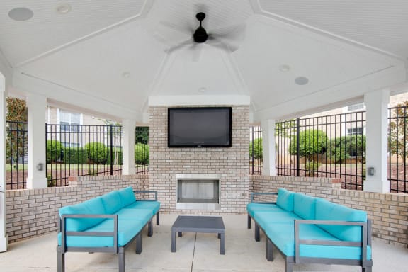 Commons Living Room with Couches and a Television at Montecito West in  Raleigh, NC 27609