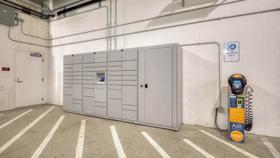 A parking garage with a white wall and a parking meter at Mosaic Summit Pointe in Chesapeake, VA
