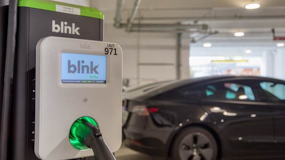 A Blink charging station is plugged into a car at Mosaic Summit Pointe in Chesapeake, 23320