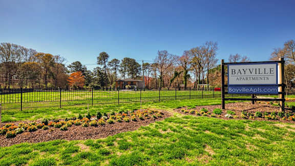 a park with a sign apartments  at Bayville Apartments, Virginia Beach, VA, 23455
