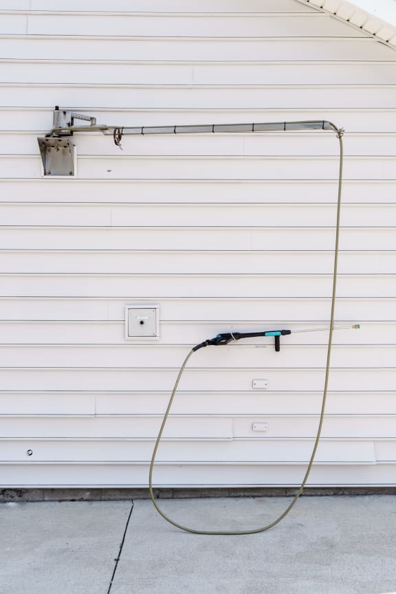 a hose plugged into the side of a garage door at Orleans Apartments, Columbus, 43221