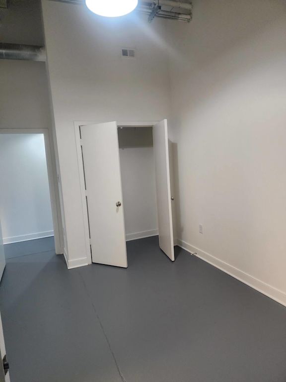 A room with a white door and a white wall.