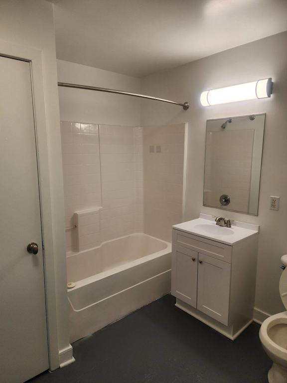 A white bathroom with a toilet, sink, and bathtub.