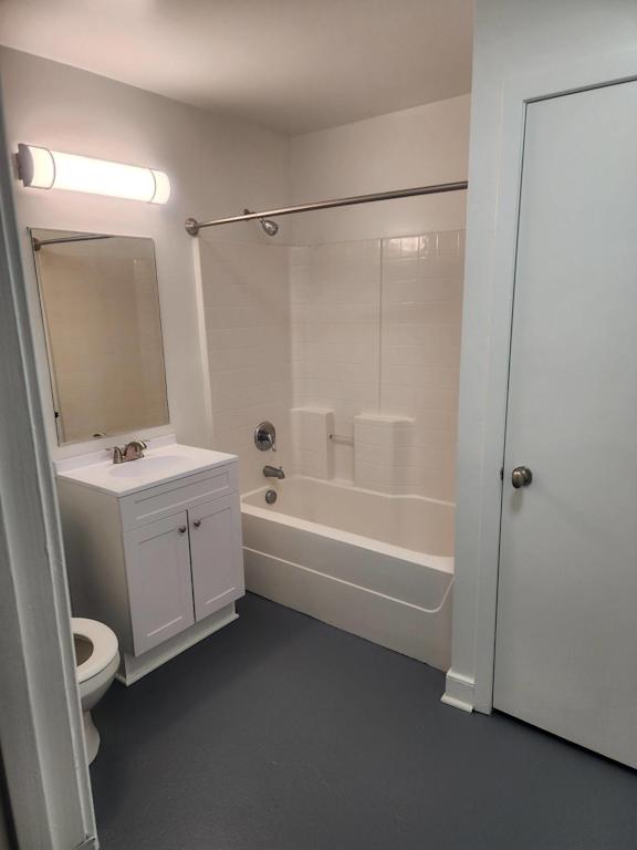 A white bathroom with a toilet, sink, and bathtub.
