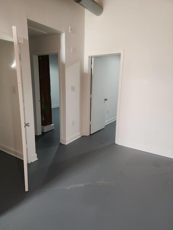 A room with three doors, one of which is open.