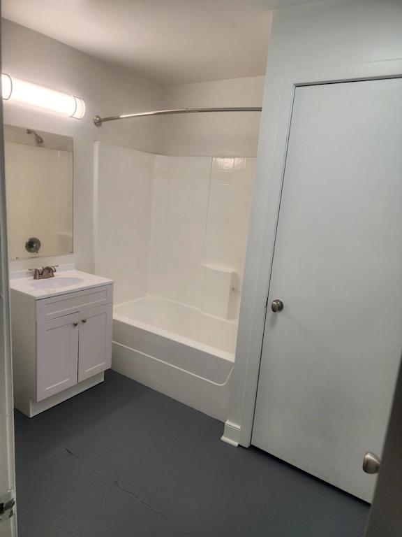 A white bathroom with a white cabinet and a white sink.