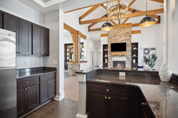 a kitchen with granite counter tops and a fireplace