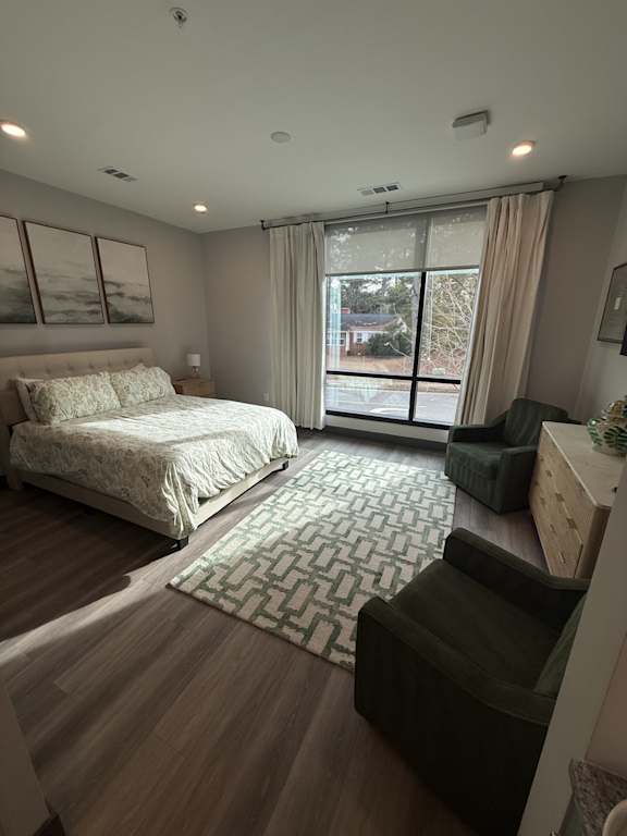 A bedroom with a large bed and a couch.