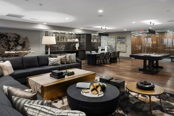 a living room with couches and tables and a pool tableat Preston Centre, Columbus