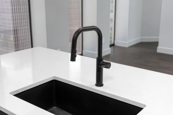 a kitchen sink with a black faucet in a new homeat Preston Centre, Columbus, OH