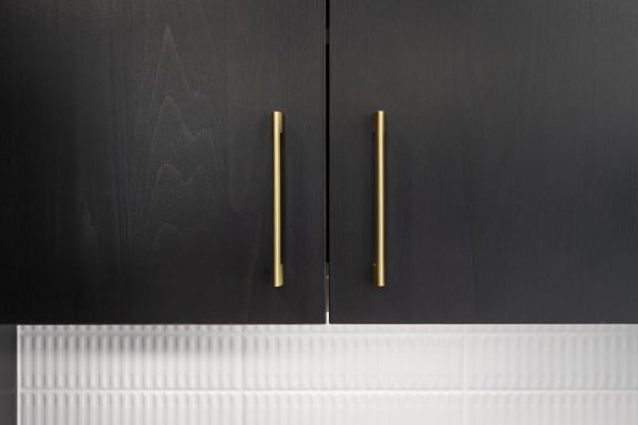 a pair of black cabinet doors with brass handles at Preston Centre, Columbus Ohio
