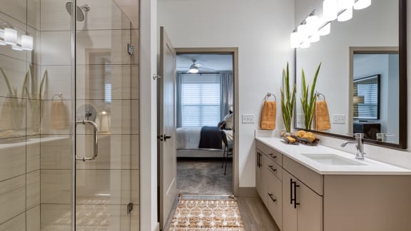 a bathroom with a shower and a sink and a mirror at Aura Stonebridge, Richmond, Virginia