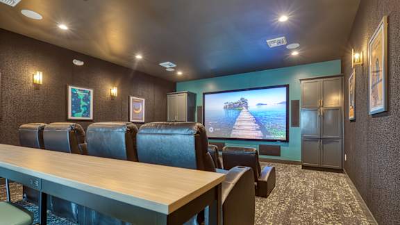 a conference room with a table and chairs and a tv on the wall at Allure at Edinburgh, Virginia