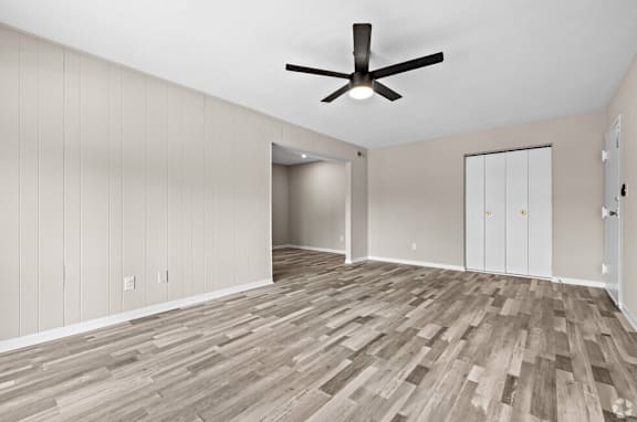 an empty living room with wood flooring and a ceiling fan at Bayville Apartments, Virginia Beach, 23455