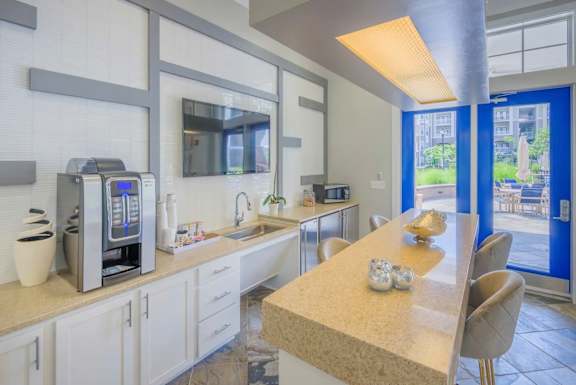 A kitchen with a table and chairs in front of a window.