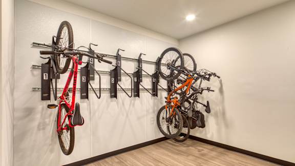 A wall-mounted bike rack with several bikes attached.