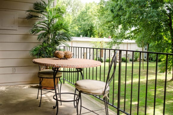 a small patio with a table and two chairs