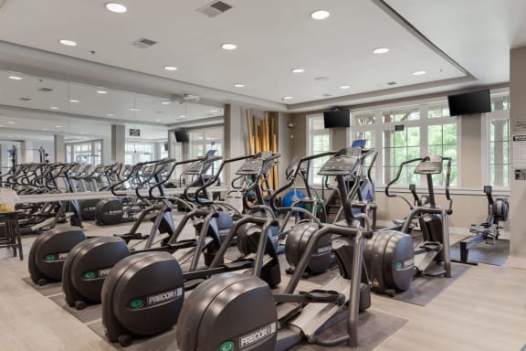 a gym with cardio equipment and weights in the lobby of a building at Orleans Apartments Apartments, OH, 43221