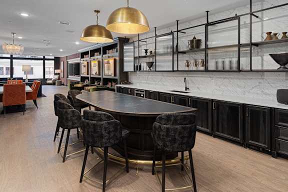 A modern kitchen with a large table and chairs.