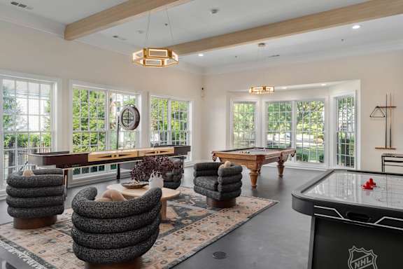 A room with a pool table and a shelf with a clock on it at The Orchard, Dublin, OH, 43016
