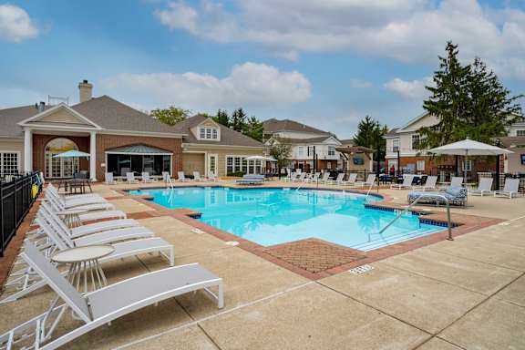 A pool with sun loungers in front of a building at The Orchard, Ohio, 43016