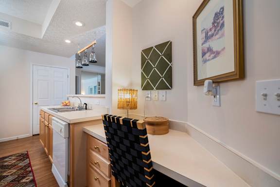 A kitchen with a white counter top and a black chair at The Orchard, Dublin, Ohio, 43016