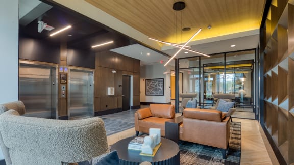 a lobby with couches and chairs and a table at Aura Stonebridge, Richmond, 23225
