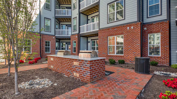 A brick wall with a planter in front of a building.
