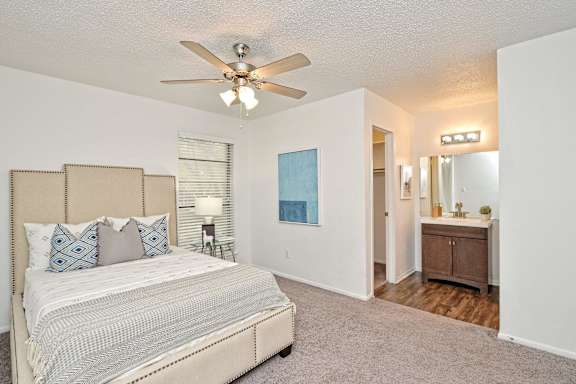 Spacious bedroom suite with attached bathroom vanity at Peaks @ NW Hills Apartments, Texas, 78731