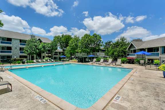 Large community swimming pool with lounge seating at Polo Club Apartments, Austin, TX