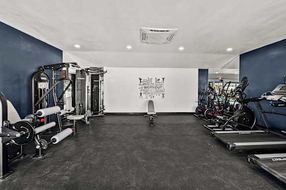 Fitness room with weight machines and workout equipment at Peaks at Live Oak Apartments, San Antonio, 78233