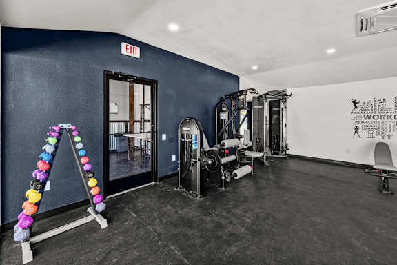 Private gym with weight equipment and exercise machines at Peaks at Live Oak Apartments, Texas, 78233