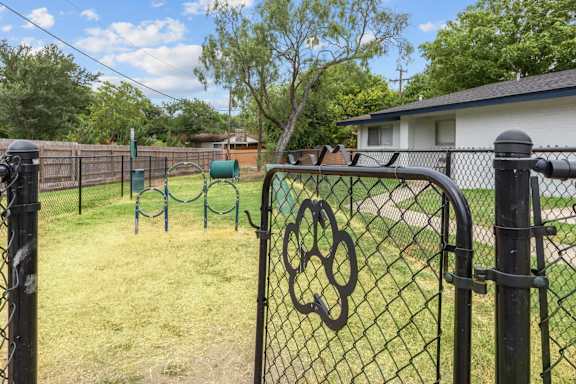 Dog park with agility hoops and play area at Peaks at Live Oak Apartments, San Antonio, Texas