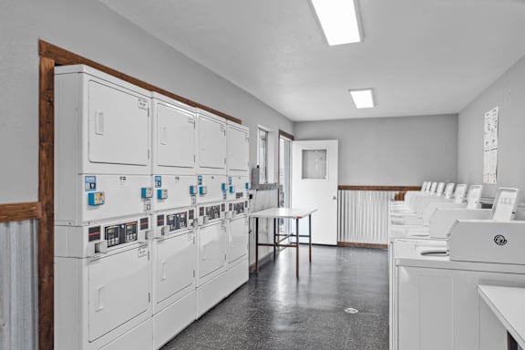 Coin operated washer and dryer stations with payment systems at Peaks at Live Oak Apartments, San Antonio, Texas