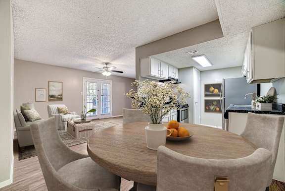 A dining room with a round table and chairs.