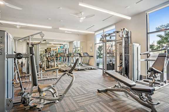 A gym with a variety of equipment including a leg press machine.