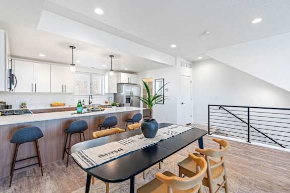 a kitchen and dining room with a table and chairs