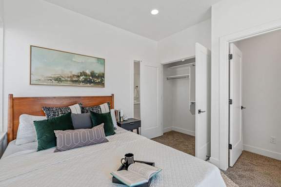 a bedroom with a bed and a painting on the wall