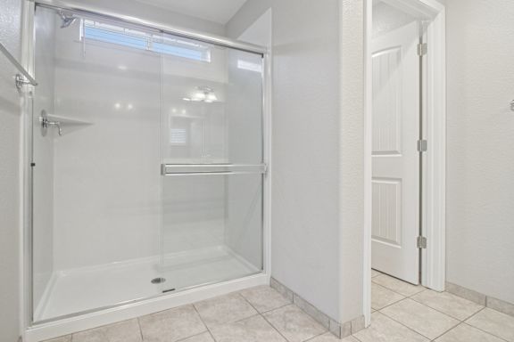 Primary bathroom with a glass shower stall.