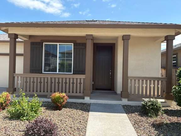 A house with a brown door and a brown porch.