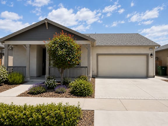 A house with a grey roof and a white garage door.